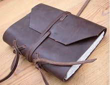 Leather portfolio with manuscript inside.